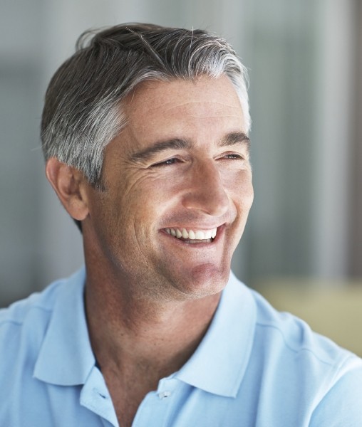Man sharing healthy smile after dental implant tooth replacement
