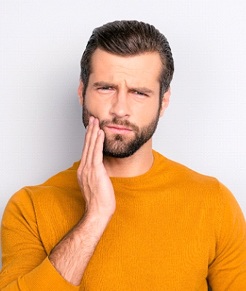 Frowning man concerned about consequences of periodontal disease