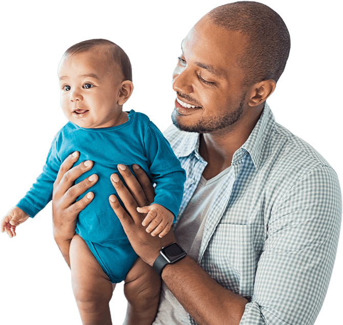 Father holding his infant son during children's dentistry visit