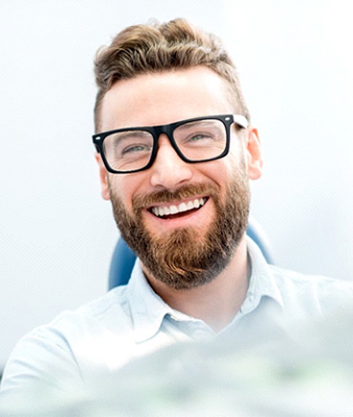 Smiling male patient enjoying benefits of dental crowns