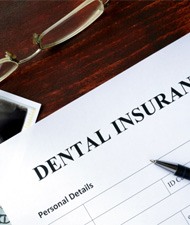 a blank dental insurance claim form with a pen sitting on top of it 