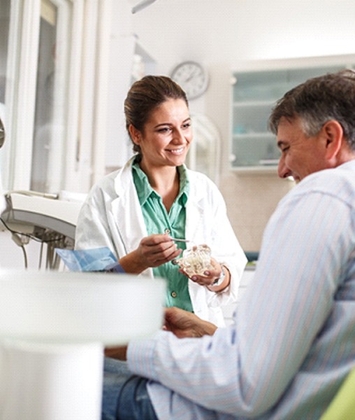 Dentist in York smiling while talking to patient about dentures