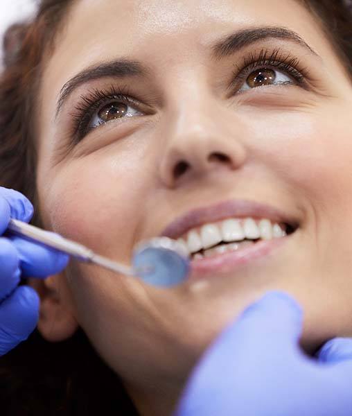 Woman receiving checkup from emergency dentist in York