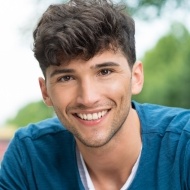 Young man with aligned smile thanks to orthodontics