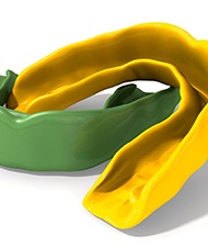 Green and yellow mouthguards isolated against white background