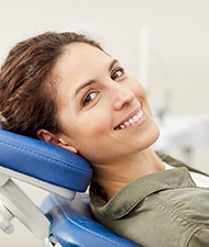 Smiling dental patient at cleaning and checkup appointment