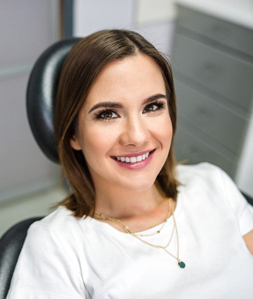 Female patient smiling after her dental implant procedure