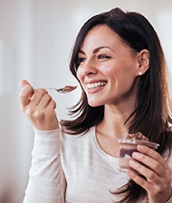 Woman eating pudding during her post-op recovery period