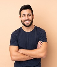 Man smiling after receiving his dental implant restorations