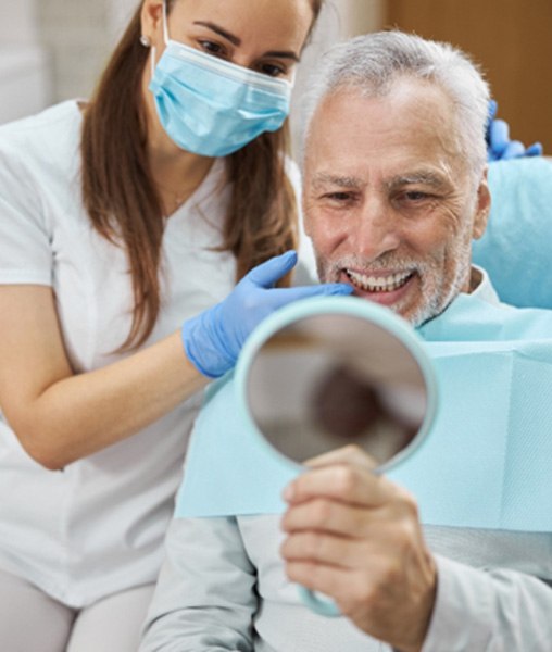 man smiling while visiting dentist