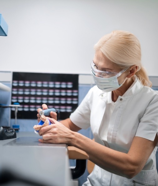 Dental team member working on denture