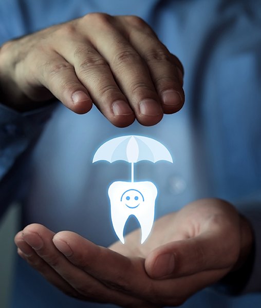 Hands holding an animted tooth under an umbrella