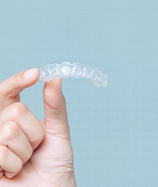 Patient holding up Invisalign in York
