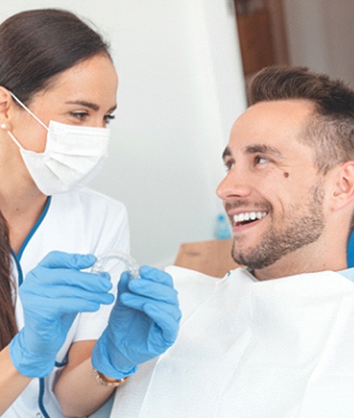 York dentist and patient talking about cost of Invisalign