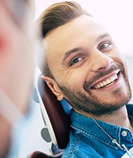 Man with straight teeth smiling at dentist
