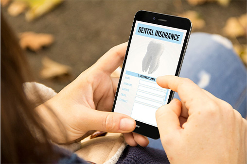 Looking at dental insurance form on smartphone