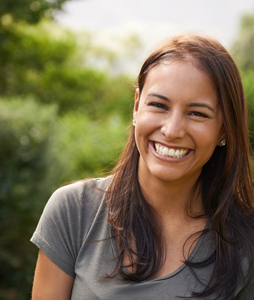 a woman smiling in a park