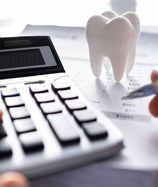a person calculating the cost of a smile makeover