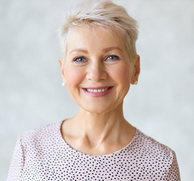 Smiling senior woman with implant-retained dentures in York