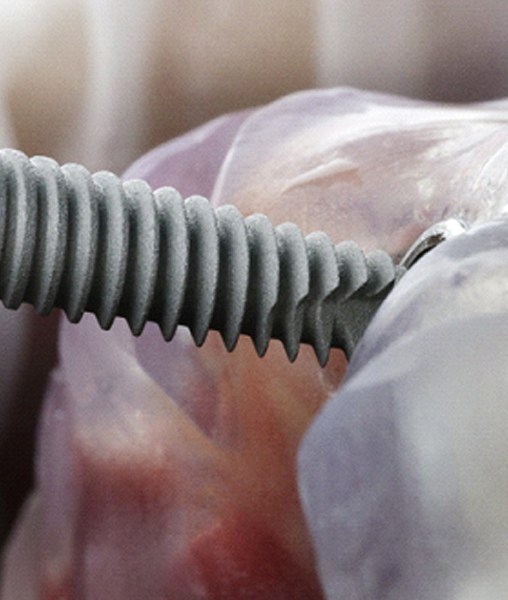 Close-up of implant being inserted into dental model