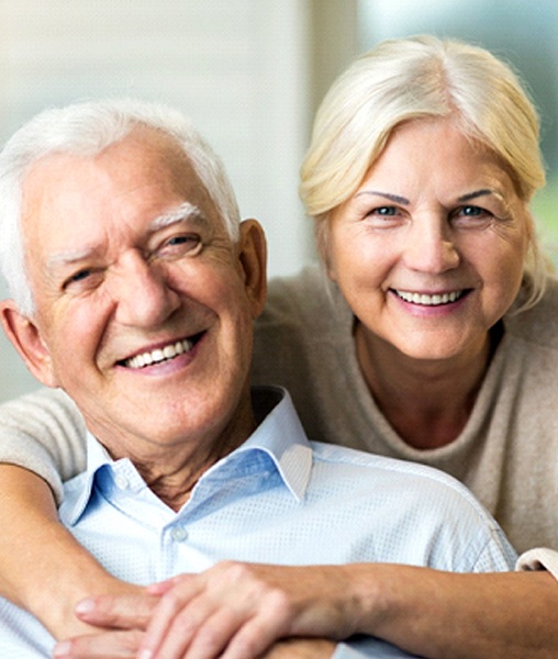 Senior couple enjoying the benefits of implant-retained dentures