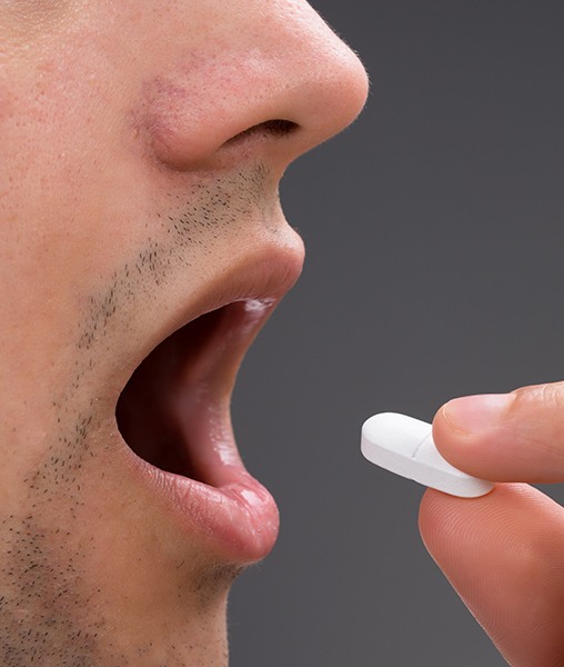 Patient taking oral conscious sedative pill