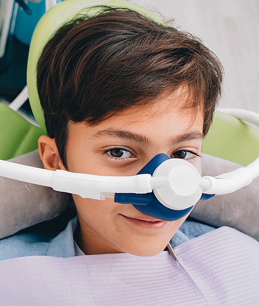 Young boy with laughing gas nitrous oxide dental sedation mask