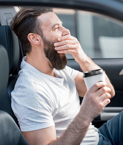 Tired man behind the wheel of his car