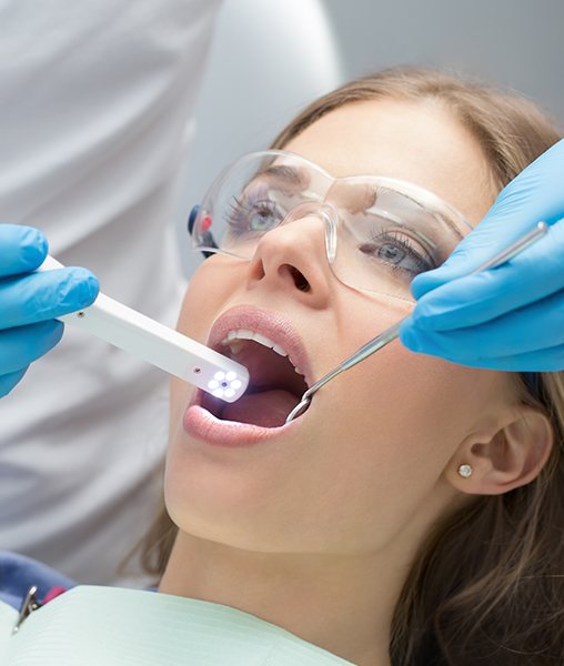 Dentist using intraoral camera to take pictures of patient's smile