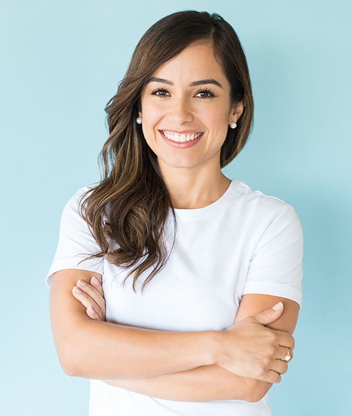 Woman with flawless smile after porcelain veneer treatment