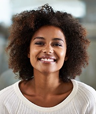 Close-up of woman in sweater smiling