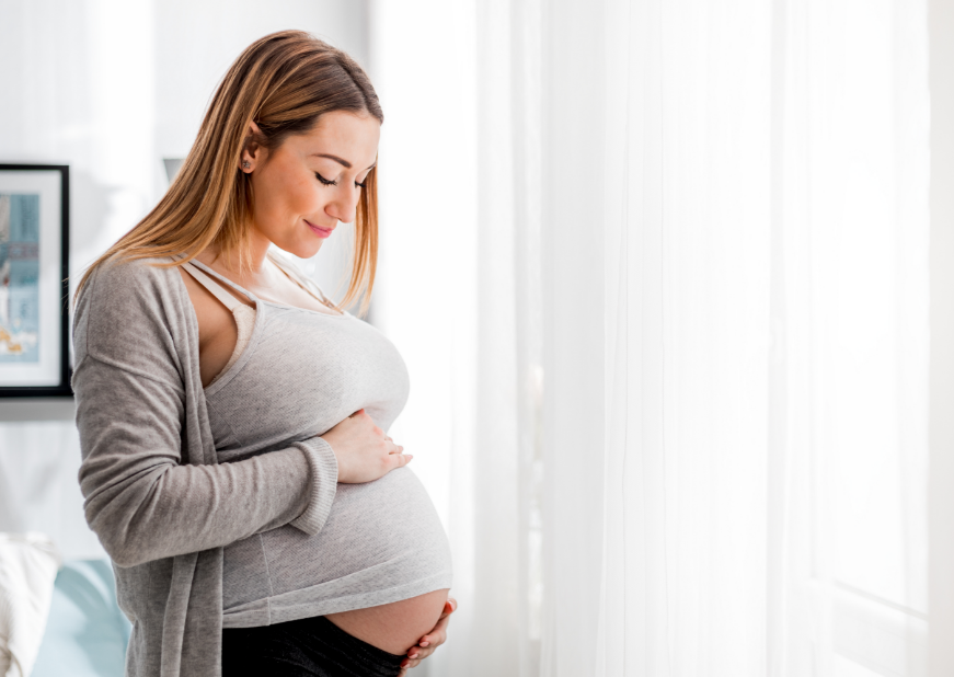 Pregnant woman holding belly